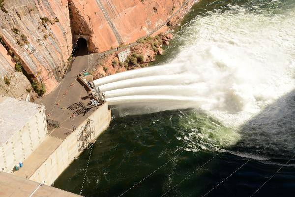 A high-flow experiment release at Glen Canyon Dam. The dam anchors the storage system governed by the new 2027-2036 operating framework.