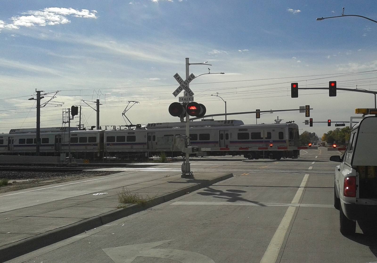 An RTD commuter rail train crosses at Sable Street. The rail district's plan assigns RTD $156 million toward construction, money the RTD board has not approved.