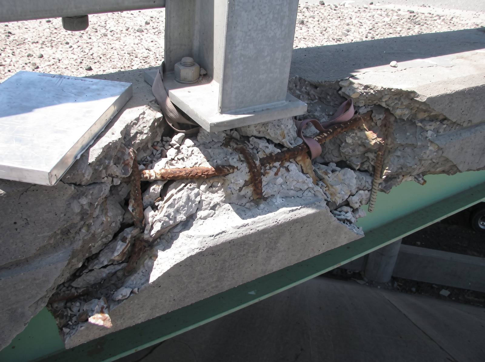 Deteriorated bridge rail, its concrete crumbled around rusted reinforcing steel, on westbound I-270 over 60th Avenue, in a Colorado Department of Transportation photograph. The bridge is one of 12 on the corridor dating to the 1960s that the project will replace.